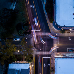 Aerial view of traffic intersection at night, metaphor for decision making.