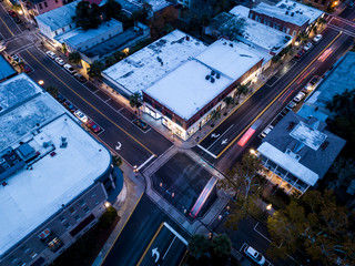 Aerial view of intersection, traffic, and stores in small town in America.