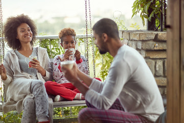 .African American family enjoy in the Christmas morning together.