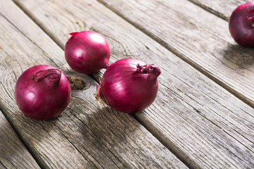 spanish onions on old rustic wood table background