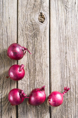 spanish onions on old rustic wood table background, top view