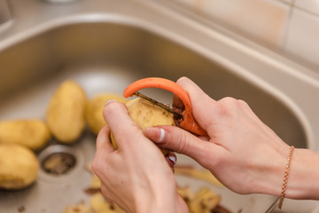 Woman peels potatoes. Cooking food. Homemade food. natural food.