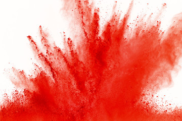 Freeze motion of red powder exploding, isolated on white background. Abstract design of red dust cloud. Particles explosion screen saver, wallpaper