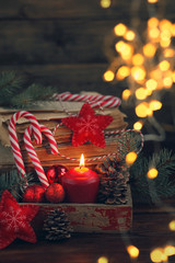 Christmas decoration on dark wooden background. toys and candle Christmas still life.  soft focus, toning