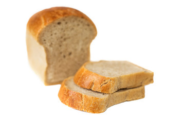 loaf of bread with chopped pieces on a whloaf of white bread with chopped pieces of selective focus isolate on a white background. white bread loaf isolated. Loaf of bread isolated on white background