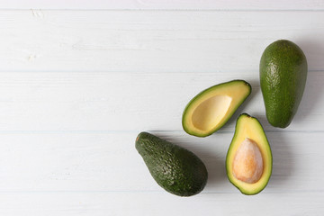  Avocado fruit on wooden table top view.