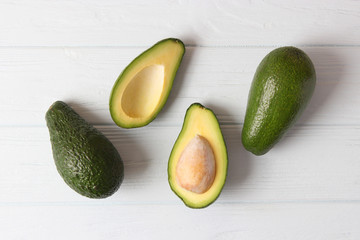  Avocado fruit on wooden table top view.