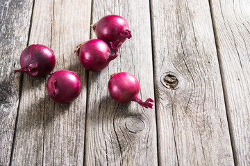 spanish onions on old rustic wood table background