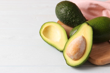  Avocado fruit on wooden table top view.