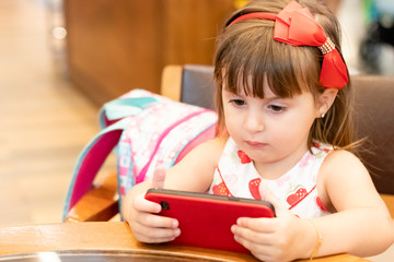 girl child concentrated on smartphone