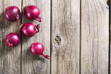 spanish onions on old rustic wood table background, top view