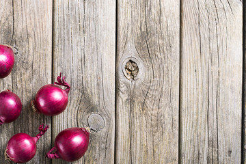 spanish onions on old rustic wood table background, top view