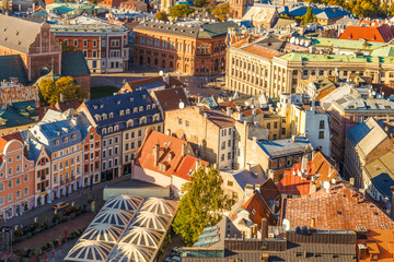Fototapeta na wymiar Riga, Latvia. Amazing view from the tower of St. Peter's Church to the old historical center of the city, amazing colourful roofs of old houses. Colorful cities concept. Travel Europe. 