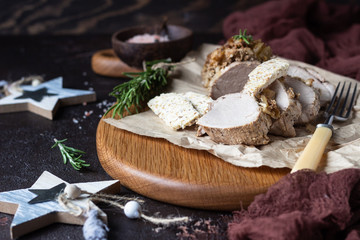 Fototapeta premium Roast pork meat with onion, garlic and rosemary served with nuts butter on brown stone table. 