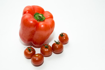 Cherry tomatoes and pepper on white background