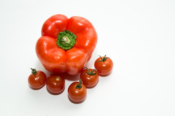 Cherry tomatoes and pepper on white background