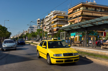 yellow taxi car on the city street, view of Athens in the summer