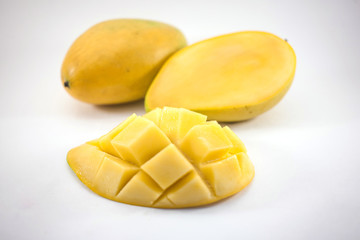 Yellow mango and mango slice with cubes isolated white background