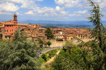 Fototapeta na wymiar Panoramic aerial view of the medieval town of Montepulciano in a sunny summer day, Tuscany, Italy. Holidays in Italy.