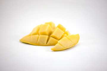 Yellow mango slice with cubes isolated white background