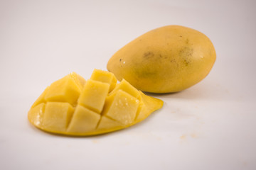 Yellow mango and mango slice with cubes isolated white background