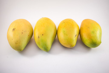 Four vietnamess mangoes on white background