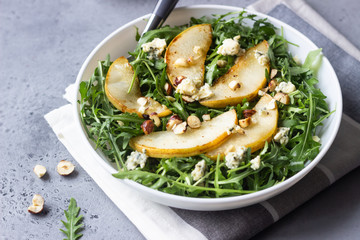 Arugula, gorgonzola cheese, caramelized pear and nut salad. Healthy food. Light breakfast, lunch or dinner. 