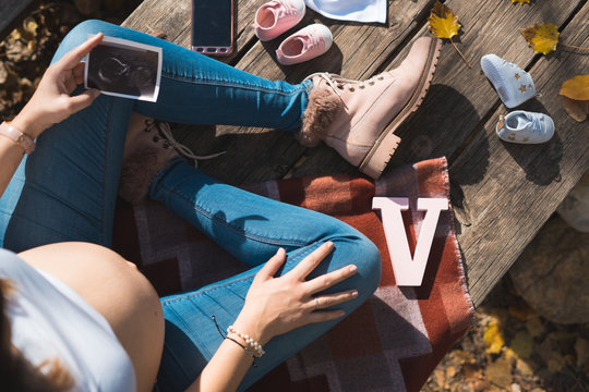 Top view of beautiful pregnant looking ultrasound image.Concept of pregnancy, health care, gynecology, medicine. Young mother waiting of the baby.