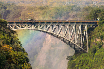 The Victoria Falls Bridge with a rainbow in the background