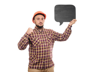 Builder worker in protective construction orange helmet holding black chalk board with space for informational tex, isolated on white background. 