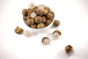 Fresh longan fruits in a white bowl isolated on white background