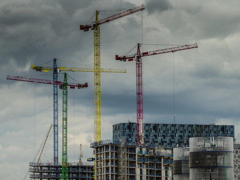 Colourful Cranes Against The Skyline In An Industrial City Landscape