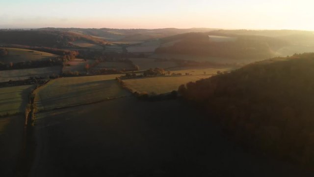 Spectacular golden sunset over rolling green hills and farmland in the Chiltern Hills, United Kingdom