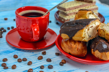 Coffee, waffles and custard cake on a light wooden background. 
