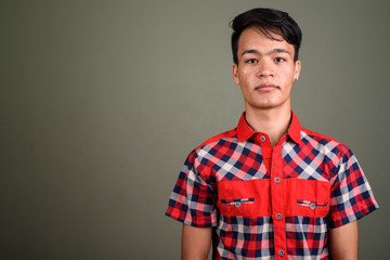 Fototapeta premium Young handsome Indian man against colored background