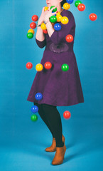 Woman in purple dress losing all colored balls.