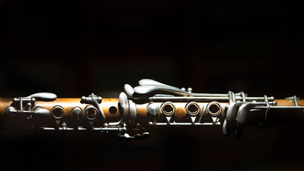 Ancient clarinet. Detail on a black background