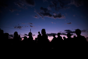 Obraz na płótnie Canvas silhouettes of people on sunset background of sky