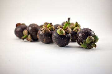 Isolated mangosteens. Plenty fruits isolated on white background