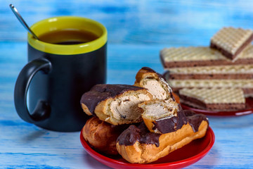 Coffee, waffles and custard cake on a light wooden background. 