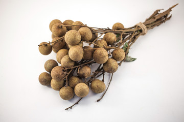 Fresh longan fruits on bench isolated on white background