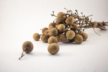 Fresh longan fruits on bench isolated on white background