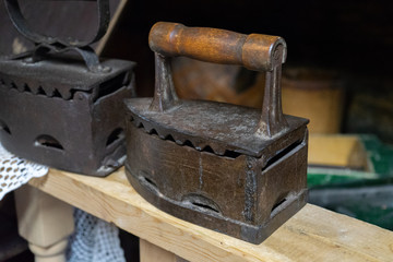 Antique iron in an old house. Iron heating from coal.