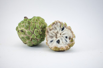 Sugar apple or custard apple with slice isolated on white background, exotic tropical Thai annona or cherimoya fruit