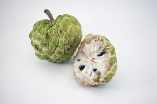 Sugar apple or custard apple with slice isolated on white background, exotic tropical Thai annona or cherimoya fruit