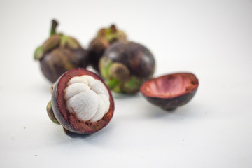 Isolated mangosteens. Four cutted fruits isolated on white background