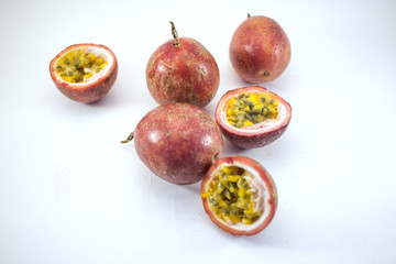Plenty of passion fruit isolated. Whole passionfruits and a halfs of maracuya isolated on white background top view