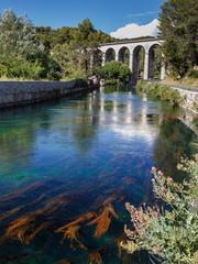 Fototapeta na wymiar Old bridge in Fontaine de Vaucluse, Provence, France. Holidays in France.