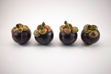 Four mangosteens isolated on white background