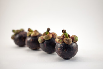 Four mangosteens isolated on white background